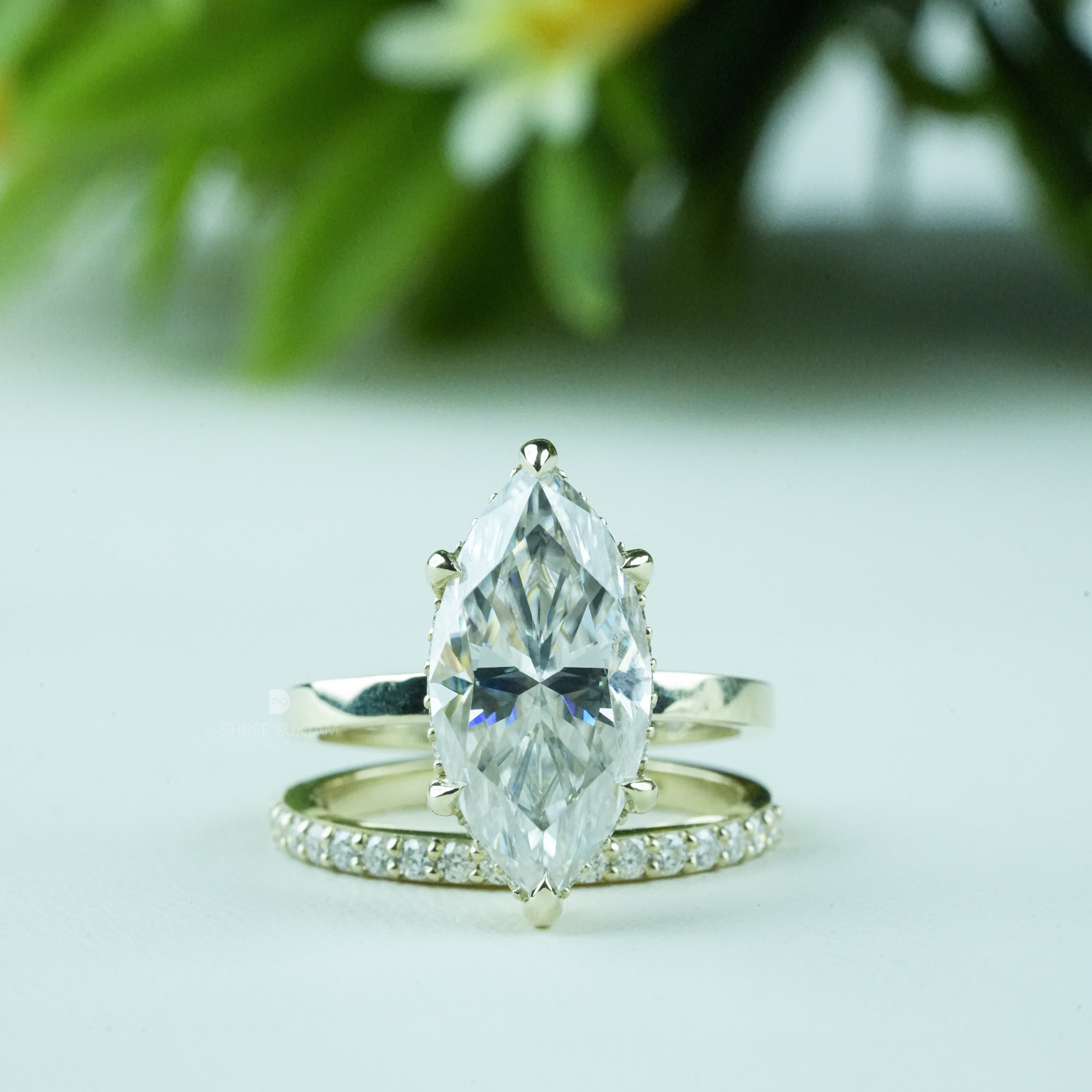 Elegant gold engagement ring set featuring a stunning marquise-cut diamond solitaire in a six-prong setting, paired with a delicate gold eternity band adorned with shimmering round diamonds. This bridal jewelry set exudes timeless sophistication and modern elegance, perfect for weddings, anniversaries, proposals, and special occasions. Ideal for women seeking a unique marquise diamond ring with a matching gold diamond band.