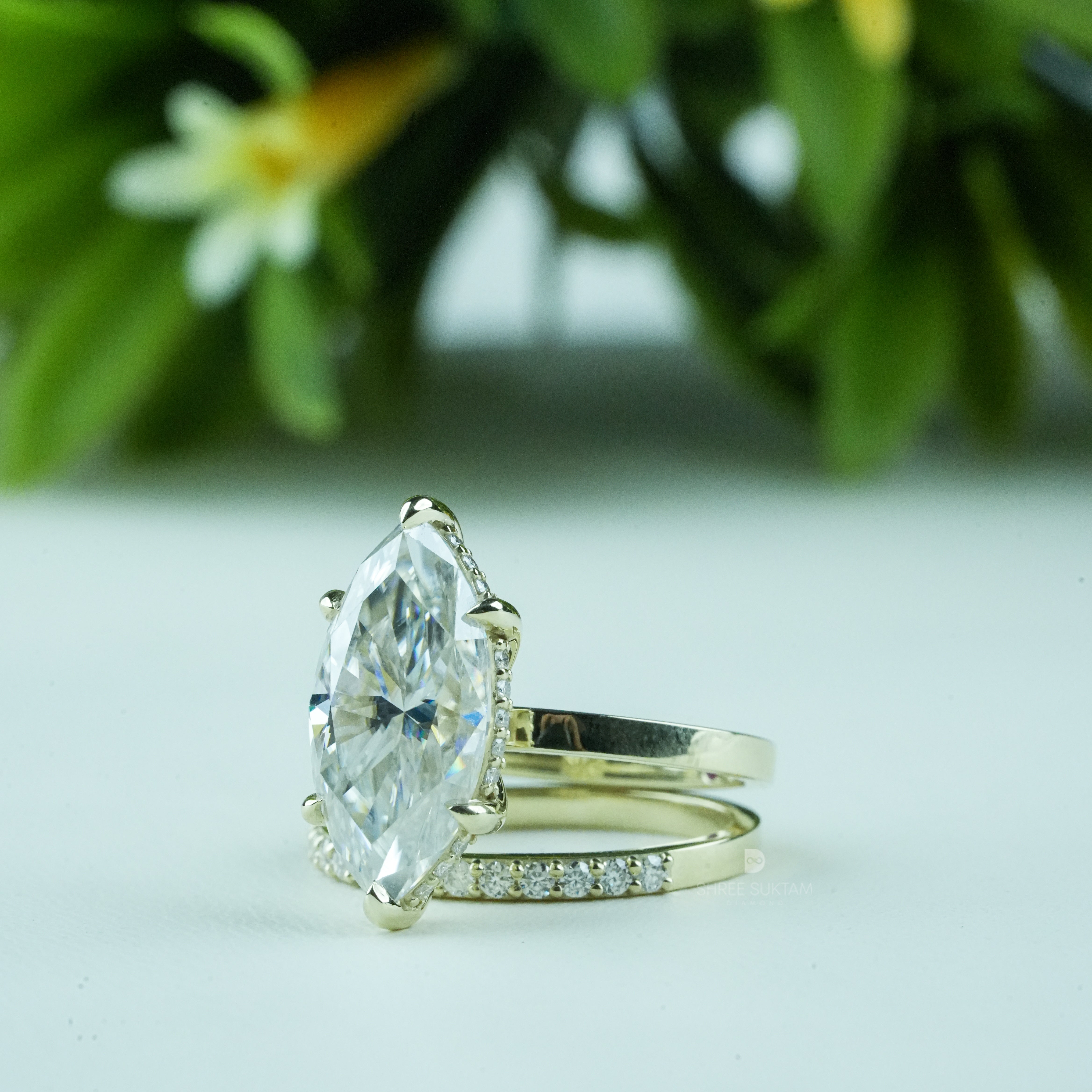 Elegant gold engagement ring set featuring a stunning marquise-cut diamond solitaire in a six-prong setting, paired with a delicate gold eternity band adorned with shimmering round diamonds. This bridal jewelry set exudes timeless sophistication and modern elegance, perfect for weddings, anniversaries, proposals, and special occasions. Ideal for women seeking a unique marquise diamond ring with a matching gold diamond band.