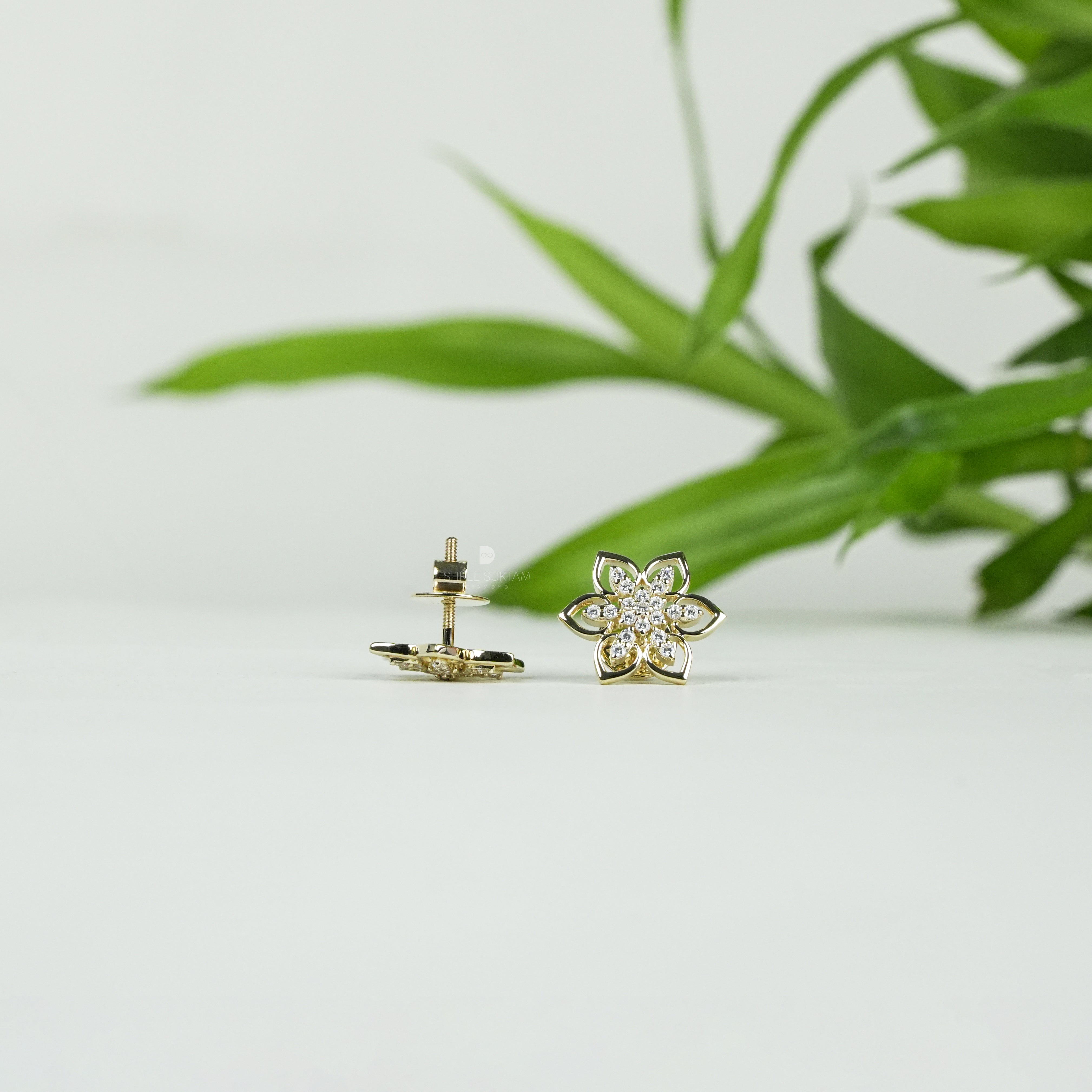 Elegant gold floral stud earrings featuring a delicate six-petal flower design adorned with sparkling cubic zirconia stones, perfect for everyday wear or special occasions. Crafted with fine attention to detail, these gold-plated earrings add a touch of timeless charm and sophistication. Ideal as a gift for women, these versatile studs pair beautifully with both casual and formal outfits, enhancing any jewelry collection.