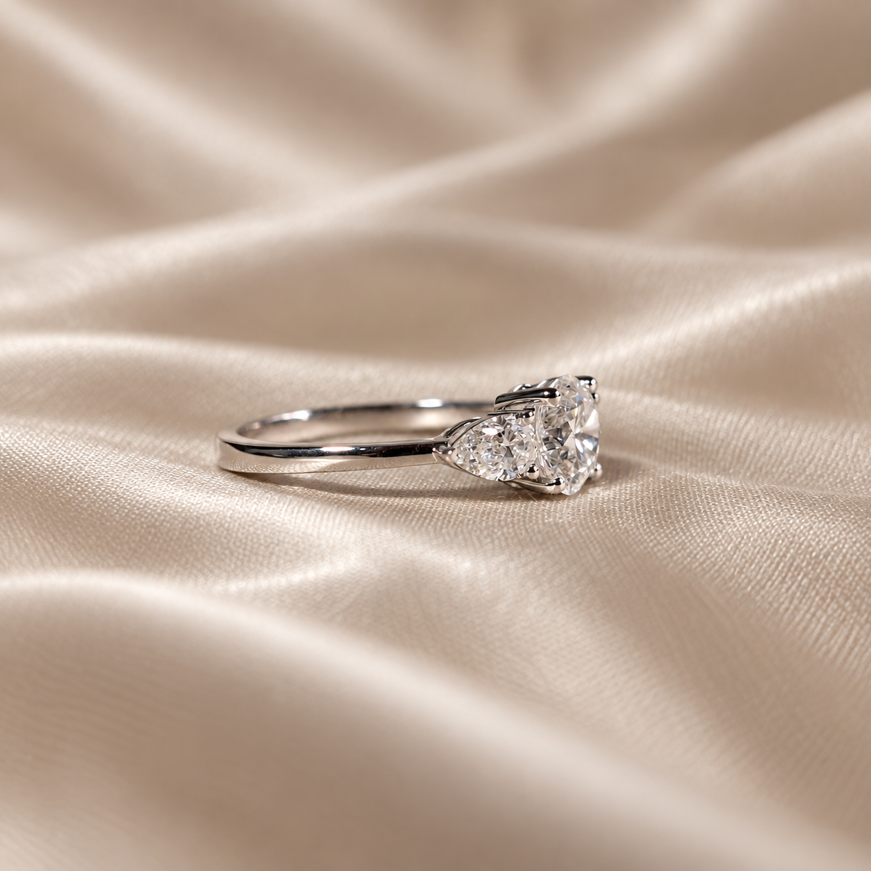 Three Stone Lab Grown Diamond Round Center with Pear Side Stone Engagement Ring
