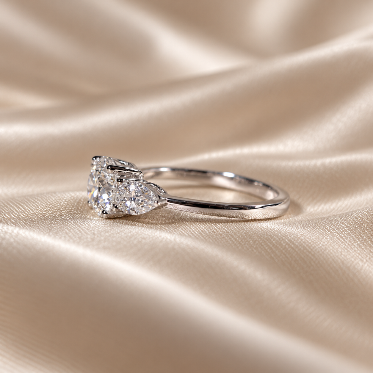 Three Stone Lab Grown Diamond Round Center with Pear Side Stone Engagement Ring